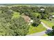 Aerial view of house, pool, and surrounding lush landscape at 7606 91St E St, Palmetto, FL 34221