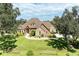 Exterior of charming two-story home with stone accents and landscaping at 7606 91St E St, Palmetto, FL 34221