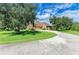 House with circular driveway and large oak trees at 7606 91St E St, Palmetto, FL 34221