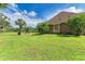 Large backyard with lush grass and partial home view at 7606 91St E St, Palmetto, FL 34221
