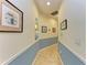 Inviting hallway with neutral paint and decorative wall art at 7606 91St E St, Palmetto, FL 34221