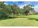 Expansive green space with mature oak trees and a pond at 7606 91St E St, Palmetto, FL 34221
