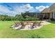 Charming fire pit surrounded by a stone patio and comfortable seating at 7606 91St E St, Palmetto, FL 34221