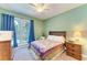 Serene bedroom with a queen-size bed and access to a screened porch at 7606 91St E St, Palmetto, FL 34221
