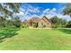 One-story home with stone accents and a lush lawn at 7606 91St E St, Palmetto, FL 34221