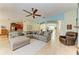 Open concept living room with a sectional sofa and views into kitchen at 7606 91St E St, Palmetto, FL 34221