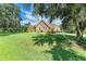 House with stone accents, landscaping, and large oak trees at 7606 91St E St, Palmetto, FL 34221