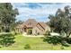 Two-story house with stone accents and a large yard at 7606 91St E St, Palmetto, FL 34221