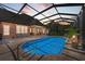Inviting pool area with covered patio, lounge chairs, and outdoor lighting at 7606 91St E St, Palmetto, FL 34221