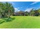 Large backyard with lush lawn and screened pool at 7606 91St E St, Palmetto, FL 34221