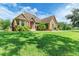 House front with stone exterior and manicured lawn at 7606 91St E St, Palmetto, FL 34221