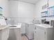 Clean laundry room with several washers and dryers at 5855 Midnight Pass Rd # 420, Sarasota, FL 34242