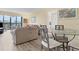 Living room with glass-top dining table and comfortable seating at 5855 Midnight Pass Rd # 420, Sarasota, FL 34242