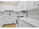 Modern kitchen with white cabinets, quartz countertops, and stainless steel appliances at 5855 Midnight Pass Rd # 420, Sarasota, FL 34242