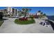 Landscaped waterfront area with seating and lush tropical foliage at 5855 Midnight Pass Rd # 420, Sarasota, FL 34242