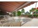 Covered patio area with seating and grilling stations at 5855 Midnight Pass Rd # 420, Sarasota, FL 34242