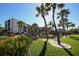 Landscaped grounds with palm trees and a pond at 5855 Midnight Pass Rd # 420, Sarasota, FL 34242