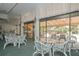 Bright community room with glass-top tables and access to a patio at 5855 Midnight Pass Rd # 420, Sarasota, FL 34242