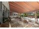 Covered patio with tables, chairs, and BBQ grills at 5855 Midnight Pass Rd # 420, Sarasota, FL 34242
