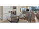 Dining area with a glass-top table and four chairs, overlooking living room at 5855 Midnight Pass Rd # 420, Sarasota, FL 34242