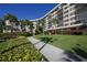Modern condo building with lush landscaping and walkways at 5855 Midnight Pass Rd # 420, Sarasota, FL 34242