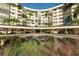Exterior view of a condominium building with lush landscaping at 5855 Midnight Pass Rd # 420, Sarasota, FL 34242