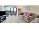 Condo living room with sofas, large windows, and water view at 5855 Midnight Pass Rd # 420, Sarasota, FL 34242