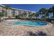 Kidney-shaped swimming pool surrounded by lounge chairs at 5855 Midnight Pass Rd # 420, Sarasota, FL 34242