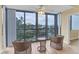 Condo living room with wicker chairs and water view at 5855 Midnight Pass Rd # 420, Sarasota, FL 34242
