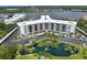 Aerial view of a condo building with a pond and parking at 5855 Midnight Pass Rd # 420, Sarasota, FL 34242