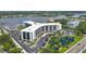 Aerial view of condo building with parking and a pond at 5855 Midnight Pass Rd # 420, Sarasota, FL 34242