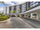 Condo building with covered parking and landscaping at 5855 Midnight Pass Rd # 420, Sarasota, FL 34242