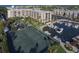 Aerial view of a waterfront community with tennis courts, marina, and resort-style amenities at 5855 Midnight Pass Rd # 420, Sarasota, FL 34242