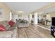 Spacious living room featuring light wood floors and comfortable seating at 5855 Midnight Pass Rd # 420, Sarasota, FL 34242