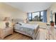 Spacious bedroom with a queen-size bed and large windows at 5855 Midnight Pass Rd # 420, Sarasota, FL 34242