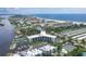 Aerial view of waterfront community, tennis courts, and marina at 5855 Midnight Pass Rd # 420, Sarasota, FL 34242
