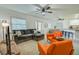 Open concept living area with orange armchairs and a kitchen view at 7305 Mauna Loa Blvd, Sarasota, FL 34241