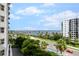 This balcony offers a view of the bay, palm trees, and road at 128 Golden Gate Pt # 501B, Sarasota, FL 34236