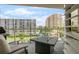 This balcony offers a seating area and a fire pit table with views of the city at 128 Golden Gate Pt # 501B, Sarasota, FL 34236