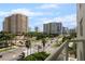 This balcony offers views of the city, palm trees, and road at 128 Golden Gate Pt # 501B, Sarasota, FL 34236