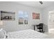 Bright bedroom with study desk, plantation shutter window with city view, and en-suite bathroom access at 128 Golden Gate Pt # 501B, Sarasota, FL 34236
