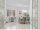 Bright dining room with modern decor including a mirrored table, velvet chairs, and decorative chandelier at 128 Golden Gate Pt # 501B, Sarasota, FL 34236