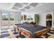 A classic game room with a pool table, kitchen, and a view of the outdoors at 128 Golden Gate Pt # 501B, Sarasota, FL 34236