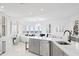 Bright kitchen with a modern island, stainless steel appliances and an open floor plan with bay window and water view at 128 Golden Gate Pt # 501B, Sarasota, FL 34236