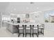 Bright kitchen with modern white cabinets, stainless steel appliances, marble countertops, and island with barstool seating at 128 Golden Gate Pt # 501B, Sarasota, FL 34236