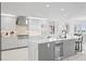 Bright kitchen features modern white cabinets, stainless steel appliances, marble countertops, and island seating at 128 Golden Gate Pt # 501B, Sarasota, FL 34236