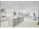 Spacious open-concept living space with marble floors, modern decor, and a seamless flow from kitchen to living room at 128 Golden Gate Pt # 501B, Sarasota, FL 34236