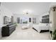 Bright main bedroom with tile floors, modern lighting, chaise lounge, and stunning views at 128 Golden Gate Pt # 501B, Sarasota, FL 34236