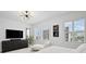 Bright main bedroom with tile floors, chaise lounge, and stunning views at 128 Golden Gate Pt # 501B, Sarasota, FL 34236