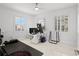 Bright office space featuring white tile floors, a ceiling fan, and lots of natural light at 128 Golden Gate Pt # 501B, Sarasota, FL 34236